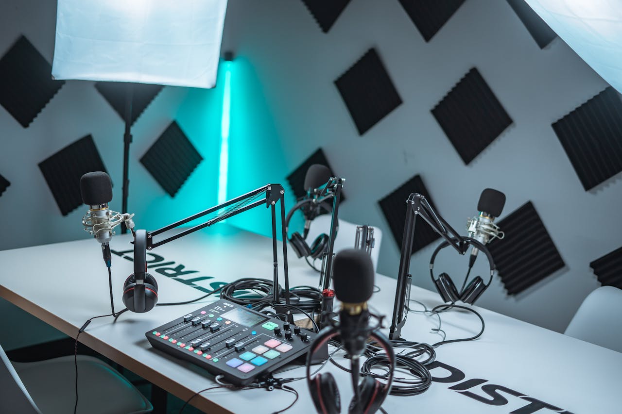 Sleek podcast studio setup featuring microphones, audio mixer, and acoustic panels.